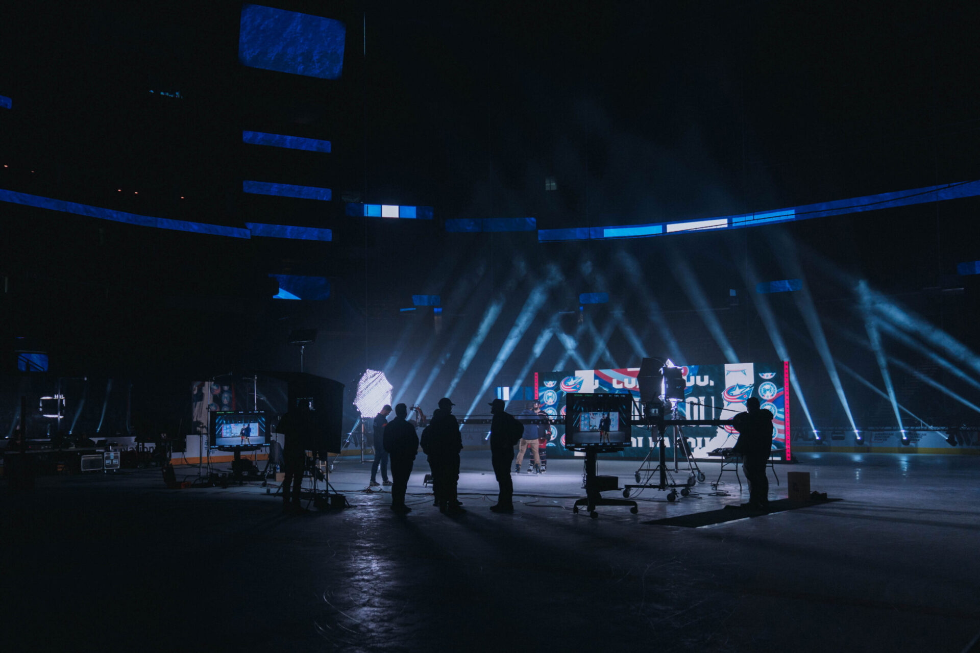 behind the scenes at a hockey rink with dark lighting shooting the Columbus Blue Jackets