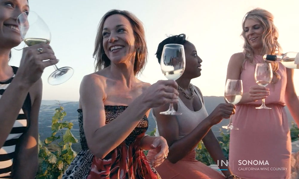 Group of 4 women drinking wine at sunset in Sonoma