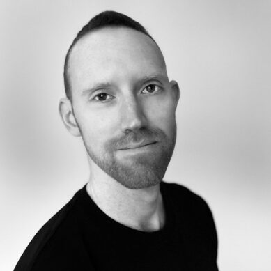 Headshot of a man with short hair and a beard