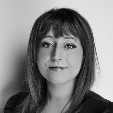 Headshot of a woman with bangs and shoulder length hair