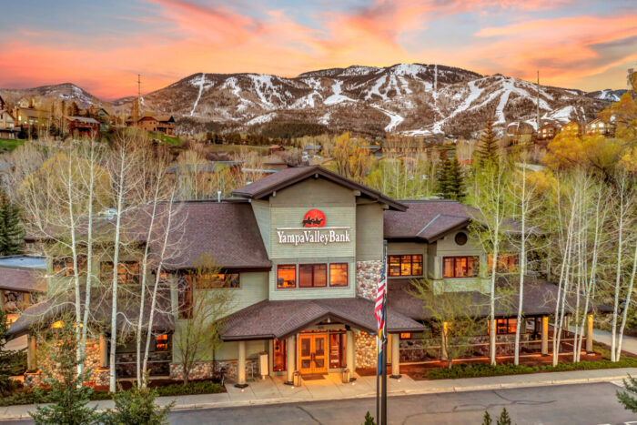 photo of yampa valley bank with sunset and mountain background