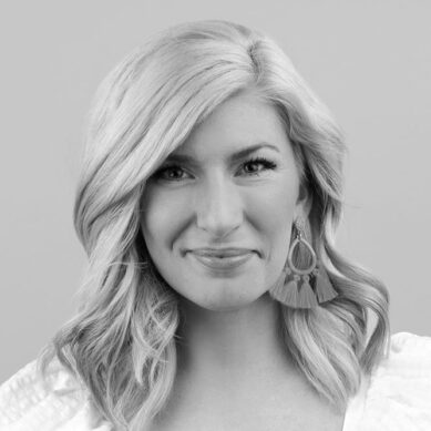 black and white headshot of marci hoxworth smiling