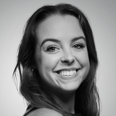 black and white headshot of mariah lung smiling in studio